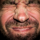 Man wincing
